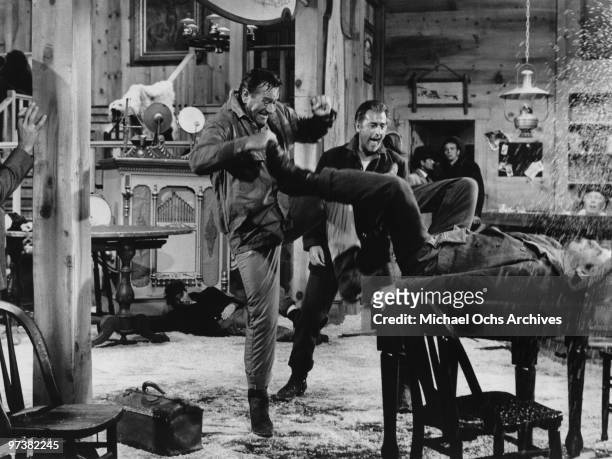 John Wayne and English actor Stewart Granger get in a bar fight on the set of the movie 'North To Alaska' in 1960.