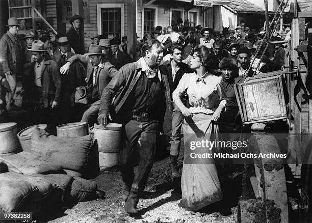 John Wayne, Capucine and Fabian on the set of the movie 'North To Alaska' in 1960 in Point Mugu, California.