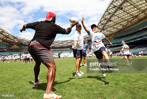 Wendell Sailor, Nathan Hindmarsh and Jarryd Hayne play backyard league with children during the 2010 NRL Club Captains media call ANZ Stadium on...