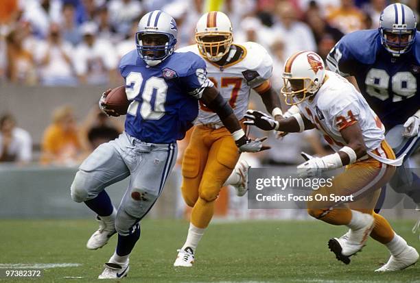 Barry Sanders of the Detroit Lions carring the ball running away from defensive back Thomas Everett of the Tampa Bay Buccaneers in a NFL football...