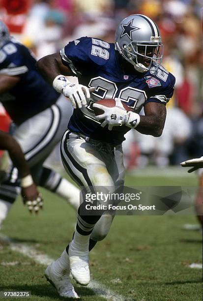 Emmitt Smith of the Dallas Cowboys carries the ball against the Arizona Cardinals October 23, 1994 during an NFL football game at Sun Devil Stadium...