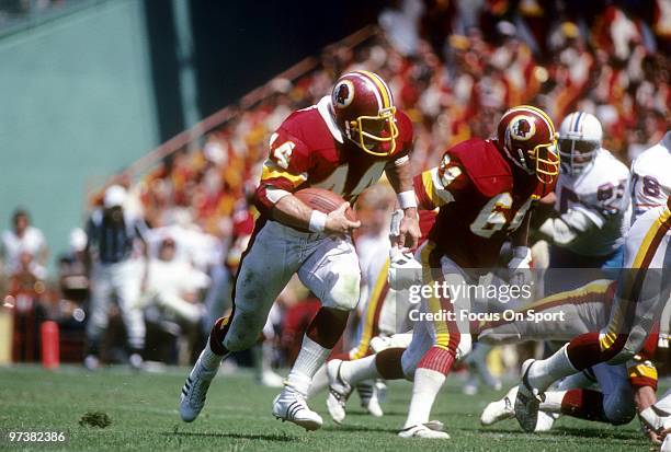 S: Running back John Riggins of the Washington Redskins carries the ball against the Houston Oilers during a circa 1980's NFL football game at RFK...