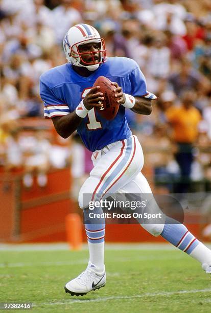 S: Quarterback Warren Moon of the Houston Oilers drops back to pass against the Miami Dolphins during a mid circa 1980's NFL football game at the...