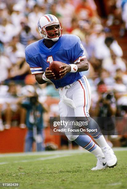 S: Quarterback Warren Moon of the Houston Oilers drops back to pass against the Miami Dolphins during a mid circa 1980's NFL football game at the...
