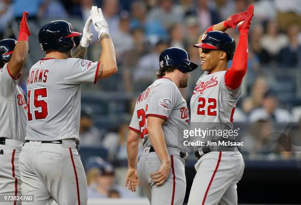 Juan Soto of the Washington Nationals celebrates his fourth inning three run home run against the New York Yankees with teammates Daniel Murphy and...