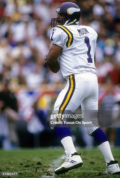 Quarterback Warren Moon of the Minnesota Vikings drops back to pass against the Green Bay Packers during an NFL football game September 4, 1994 at...