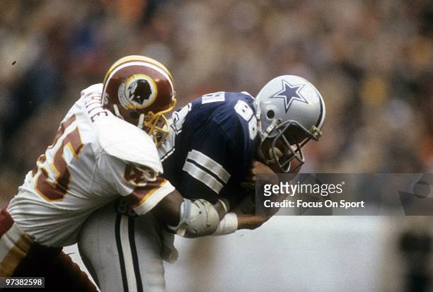 S: Wide Receiver Drew Pearson of the Dallas Cowboys after catching a pass is wrapped up by defensive back Jeris White of the Washington Redskins...