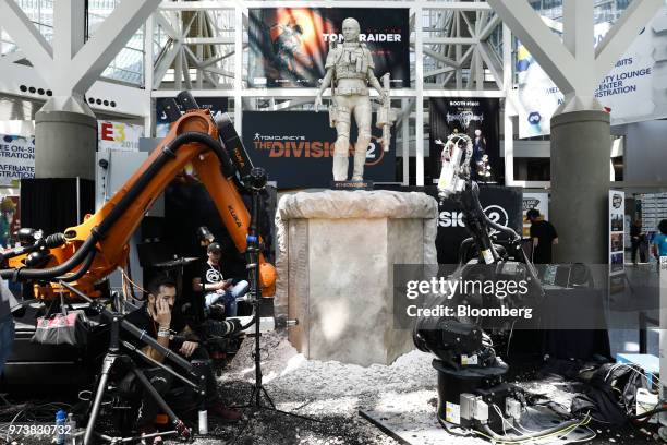 Robots craft a statue of a character for UbiSoft Entertainment SA Tom Clancy's The Division 2 video game during the E3 Electronic Entertainment Expo...