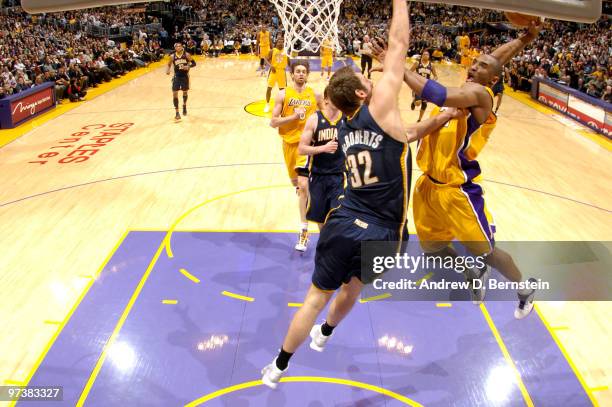 Kobe Bryant of the Los Angeles Lakers goes up for a dunk against Josh McRoberts of the Indiana Pacers at Staples Center on March 2, 2010 in Los...