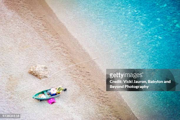 boat, rock and water from above at positano, italy - above and beyond stockfoto's en -beelden