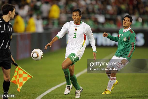 Edemir Rodriguez of Bolivia guards the ball as it rolls out of bounds during a friendly match against Pablo Barrera of Mexico in preparation for the...