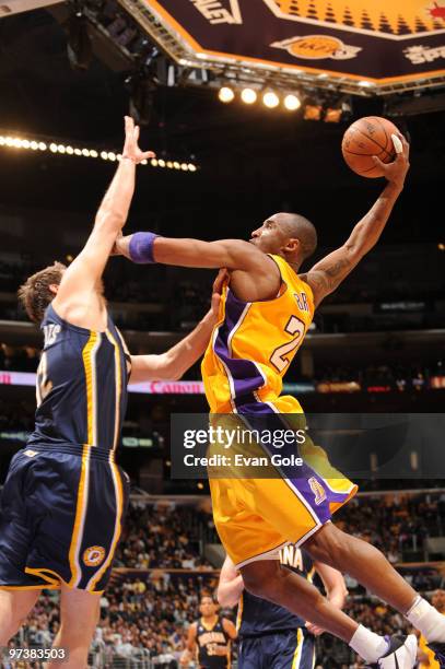 Kobe Bryant of the Los Angeles Lakers rises for a dunk against Josh McRoberts of the Indiana Pacers at Staples Center on March 2, 2010 in Los...