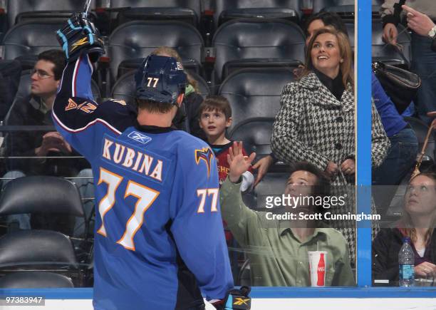 Pavel Kubina of the Atlanta Thrashers gives his stick to a young fan after the game against the Florida Panthers at Philips Arena on March 2, 2010 in...