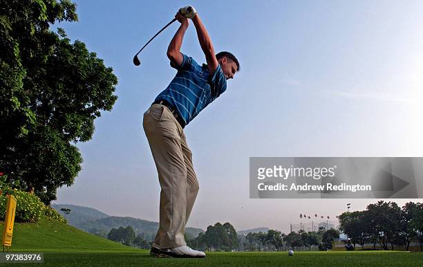 Peter Lawrie of Ireland hits his tee-shot on the 16th hole during practice prior to the start of the Maybank Malaysian Open at the Kuala Lumpur Golf...