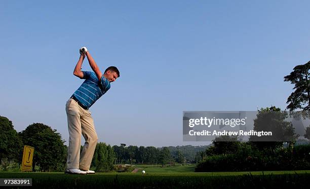 Peter Lawrie of Ireland hits his tee-shot on the 17th hole during practice prior to the start of the Maybank Malaysian Open at the Kuala Lumpur Golf...