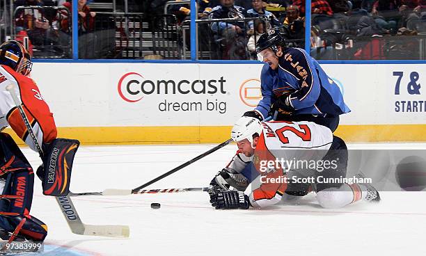 Bryan McCabe of the Florida Panthers defends against Bryan Little of the Atlanta Thrashers at Philips Arena on March 2, 2010 in Atlanta, Georgia.