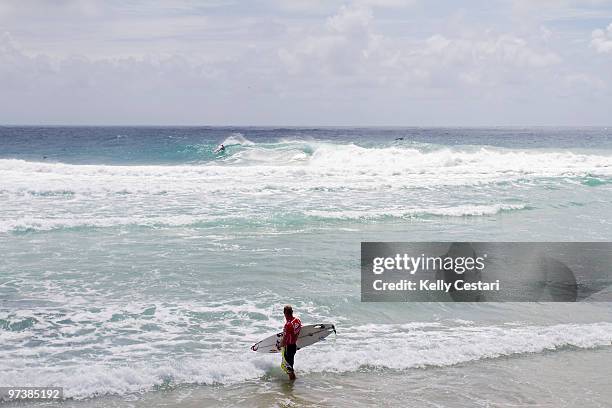 Mick Fanning of Australia looks back to the lineup as he competes in the Quiksilver Pro 2010 as part of the ASP World Tour at Snapper Rocks on March...