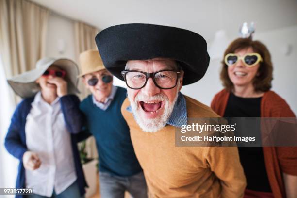 two senior couples having fun at a party at home. - man open mouth stock pictures, royalty-free photos & images