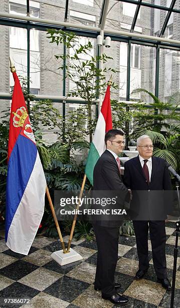 Serbian Foreign Minister Vuk Jeremic poses with his Hungarian counterpart Peter Balazs after a press conference after their bilateral meeting in the...