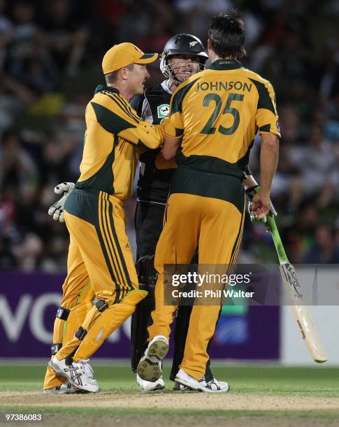 Brad Haddin runs in to seperate Scott Styris of New Zealand and Mitchell Johnson of Australia during an exchange of words during the First One Day...