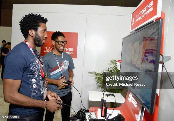 Nyambi Nyambi and Alphonso McAuley visit the Nintendo booth during the 2018 E3 Gaming Convention at Los Angeles Convention Center on June 13, 2018 in...