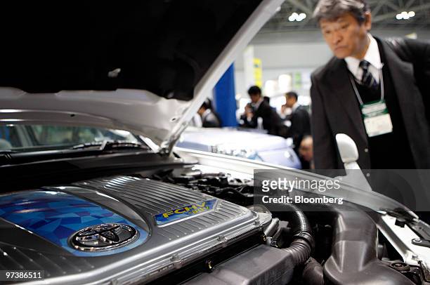 Visitor looks at a Toyota Motor Corp. FCHV-adv fuel cell vehicle at the 6th International Hydrogen & Fuel Cell Expo in Tokyo, Japan, on Wednesday,...