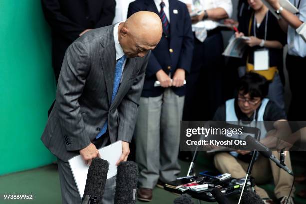 Shigakkan University wrestling team coach and former development director at Japan Wrestling Federation Kazuhito Sakae bows in front of members of...