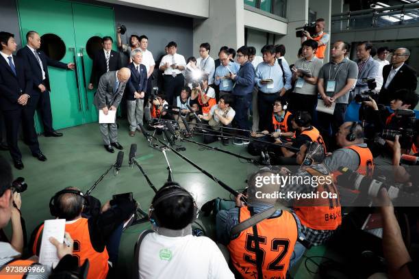 Shigakkan University wrestling team coach and former development director at Japan Wrestling Federation Kazuhito Sakae bows in front of members of...