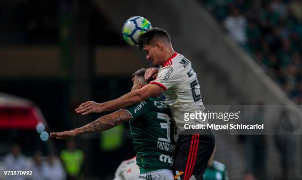Matheus Thuler of Flamengo scores for a gol with Thiago Martins of Palmeiras during a match between Palmeiras and Flamengo for the Brasileirao Series...