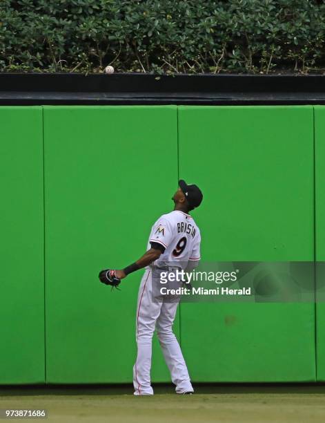 Miami Marlins center fielder Lewis Brinson looks the baseball over the fence after the San Francisco Giants' Andrew McCutchen hit a two-run home run...