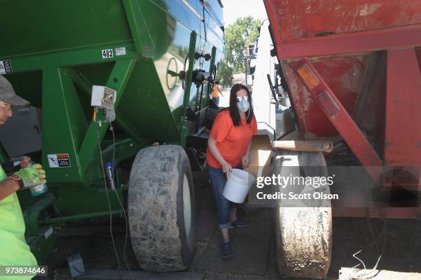 Jamie Ballenger takes a sample of soybeans to test the quality as they are loaded into a shipping container at a Ruff Bros. Grain elevator on June...