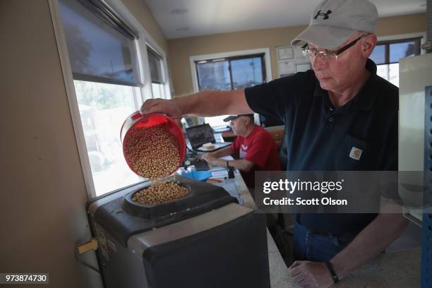 Greg Lovins checks the quality of a load of soybeans being delivered to a Ruff Bros. Grain elevator on June 13, 2018 in Blackstone, Illinois. U.S....