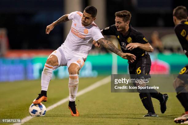 Atlanta United FC defender Franco Escobar battles with Columbus Crew SC midfielder Luis Argudo to keep the ball in bounds in the MLS regular season...