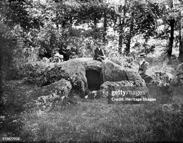 Waylands Smithy, Ashbury, Oxfordshire, circa 1860-circa 1922. The neolithic chambered long barrow, taken from the west, with a lady and gentleman...