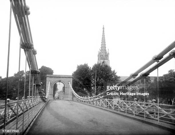 Marlow Bridge, Buckinghamshire, circa 1860-circa 1922. Looking along the suspension bridge over the River Thames, which was designed by William...