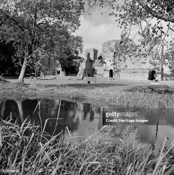 Minster Lovell Hall, Oxfordshire, 1970. View across the River Windrush towards the remains of Minster Lovell Hall with St Kenelm's Church beyond....