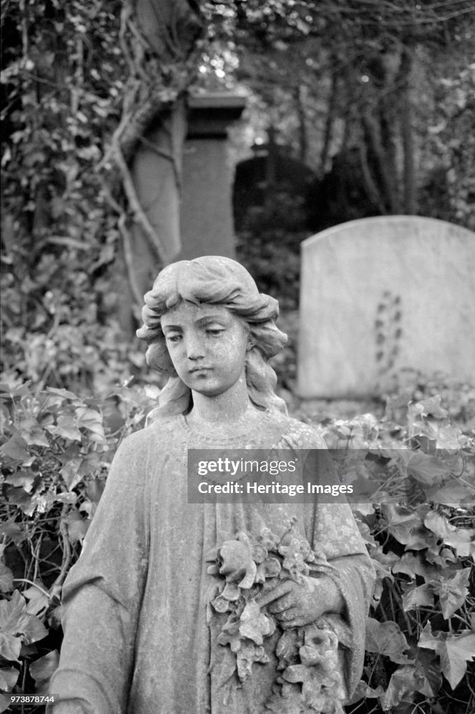 Statue Of A Girl Holding Flowers