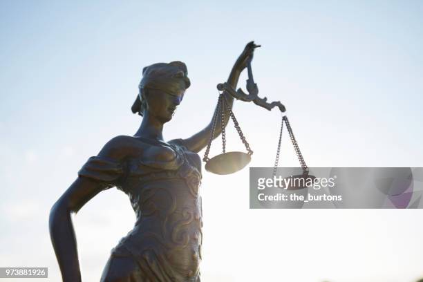lady justice against clear sky - law scales stock pictures, royalty-free photos & images