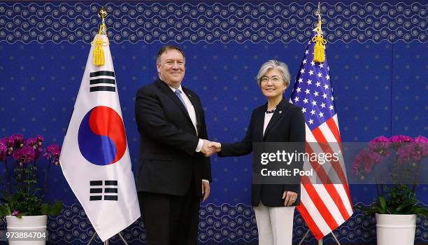 Secretary of State Mike Pompeo shakes hands with South Korean Foreign Minister Kang Kyung-wha during their meeting at foreign ministry on June 14,...