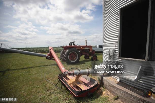 Farmer John Duffy loads soybeans from his grain bin onto a truck before taking them to a grain elevator on June 13, 2018 in Dwight, Illinois. U.S....