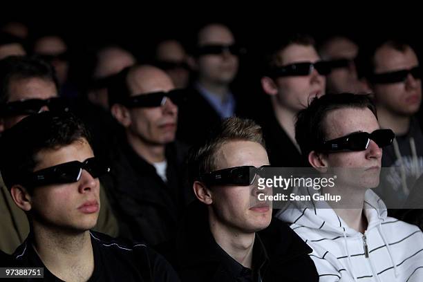 Visitors watch a 3D cinematic demonstration promoting NVIDIA graphic processors at the CeBIT Technology Fair on March 3, 2010 in Hannover, Germany....