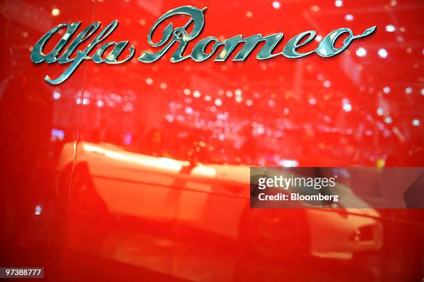 An Alfa Romeo Spider automobile is seen reflected on the second press day of the Geneva International Motor Show in Geneva, Switzerland, on...