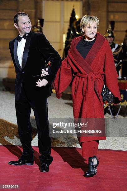 French singer Patricia Kaas arrives with her companion at the Elysee palace in Paris to attend an official dinner between French President Nicolas...