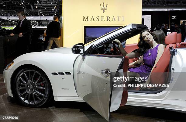 Model poses sitting in the new Maserati GranCabrio on March 3, 2010 during the third press day at the 80th Geneva International Motor Show at Palexpo...