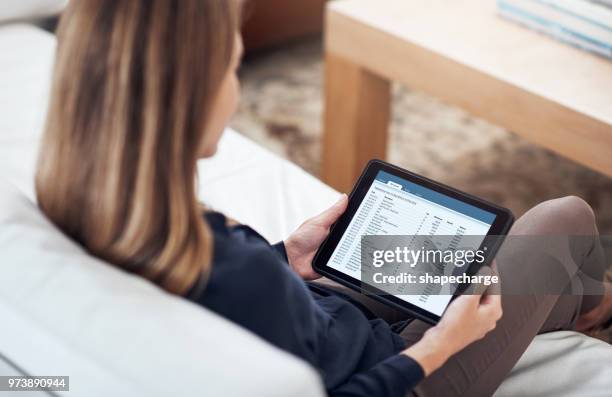 managing her banking transactions from home - over the shoulder view stock pictures, royalty-free photos & images