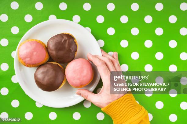 hand picking donut - blue donut white background stock pictures, royalty-free photos & images