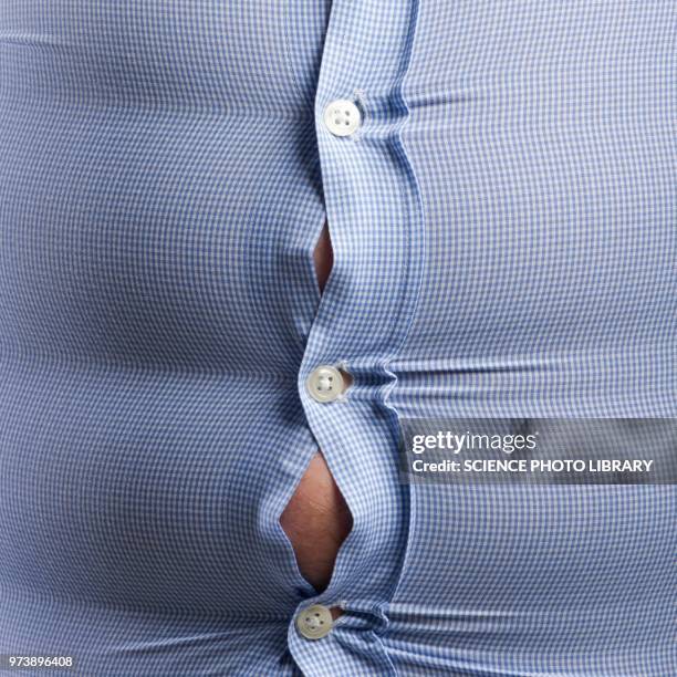 overweight man with bulging shirt buttons - stretto foto e immagini stock