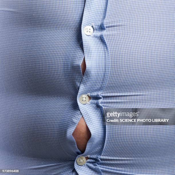 overweight man with bulging shirt buttons - men bulge imagens e fotografias de stock