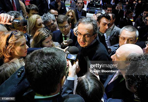 Sergio Marchionne, chief executive officer of Fiat SpA, center, speaks to journalists on the second press day of the Geneva International Motor Show...