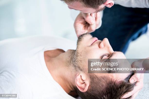 checking breathing - first aid training stock pictures, royalty-free photos & images